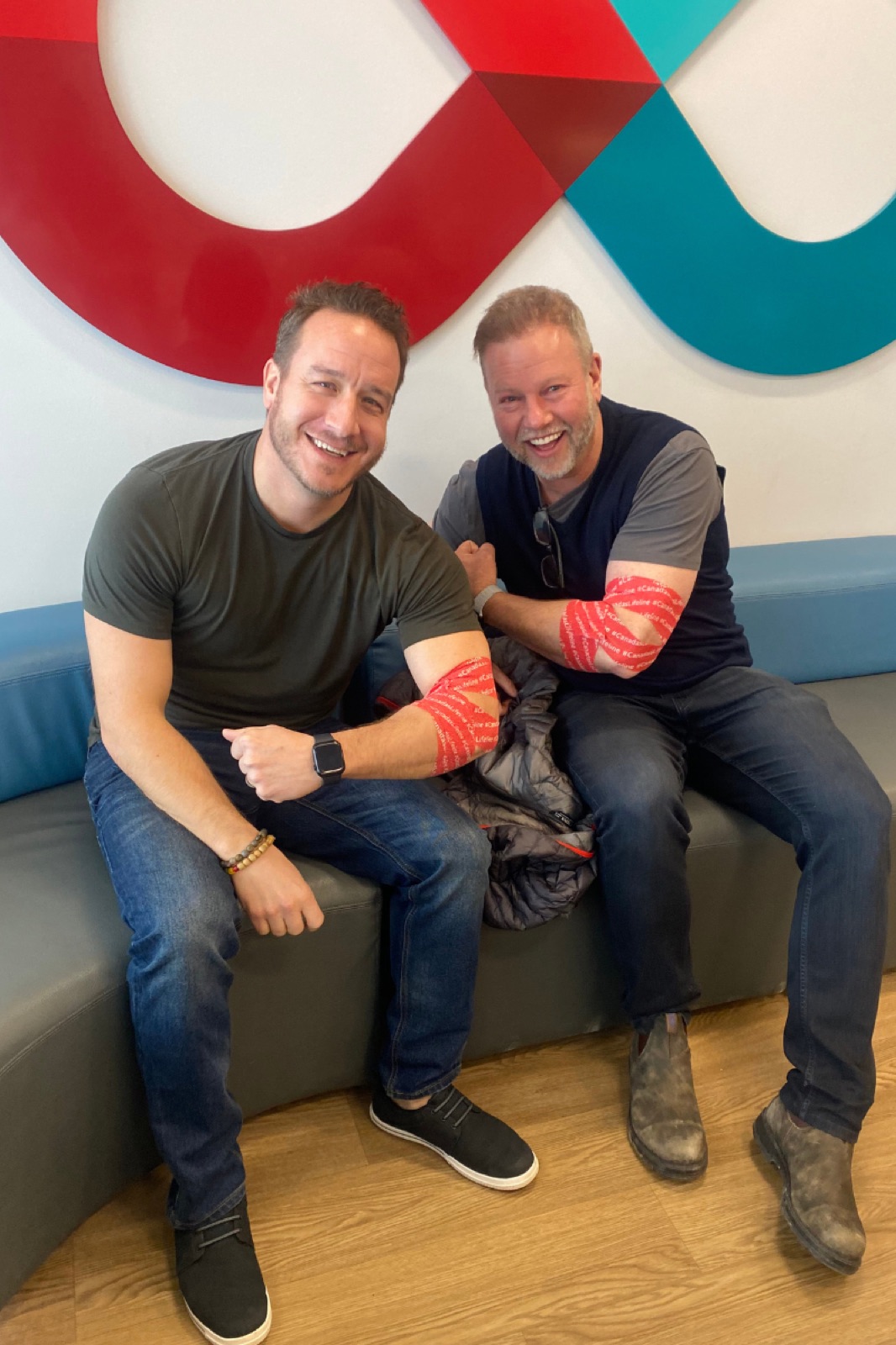 Dan Gregoire and Doug Gordon of The Gordon Brothers Team giving blood at a local donation clinic