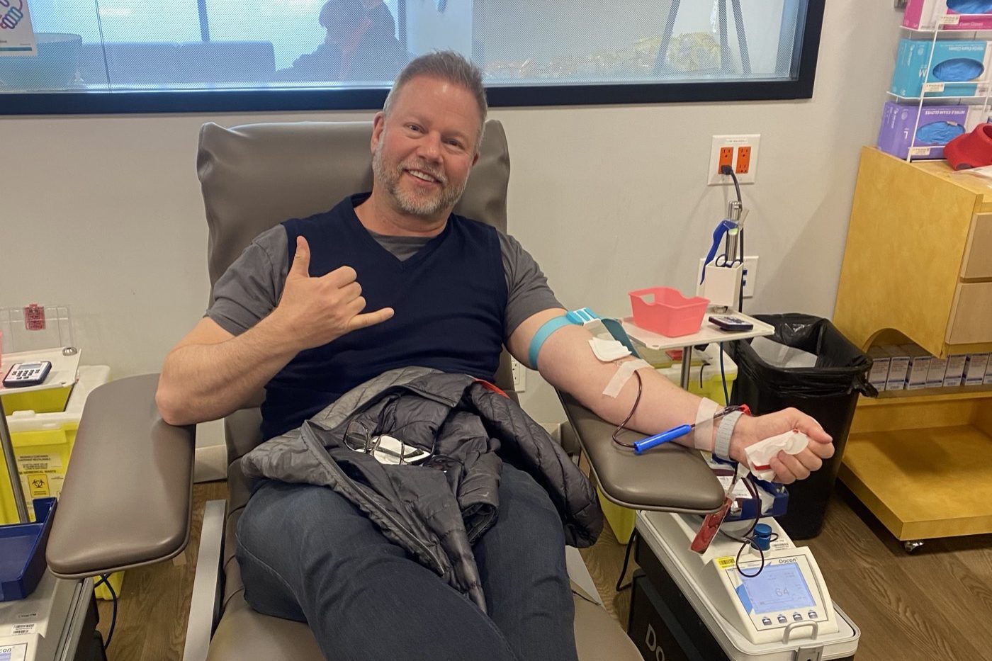 Doug Gordon of The Gordon Brothers Team donating blood at a community blood donation clinic