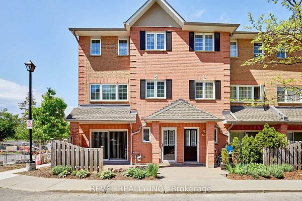 Front exterior of 1400 The Esplanade N #411, Pickering: a red brick three-storey townhome in a gated Town Centre community, listed by The Gordon Brothers Team, Revel Realty Inc., Brokerage