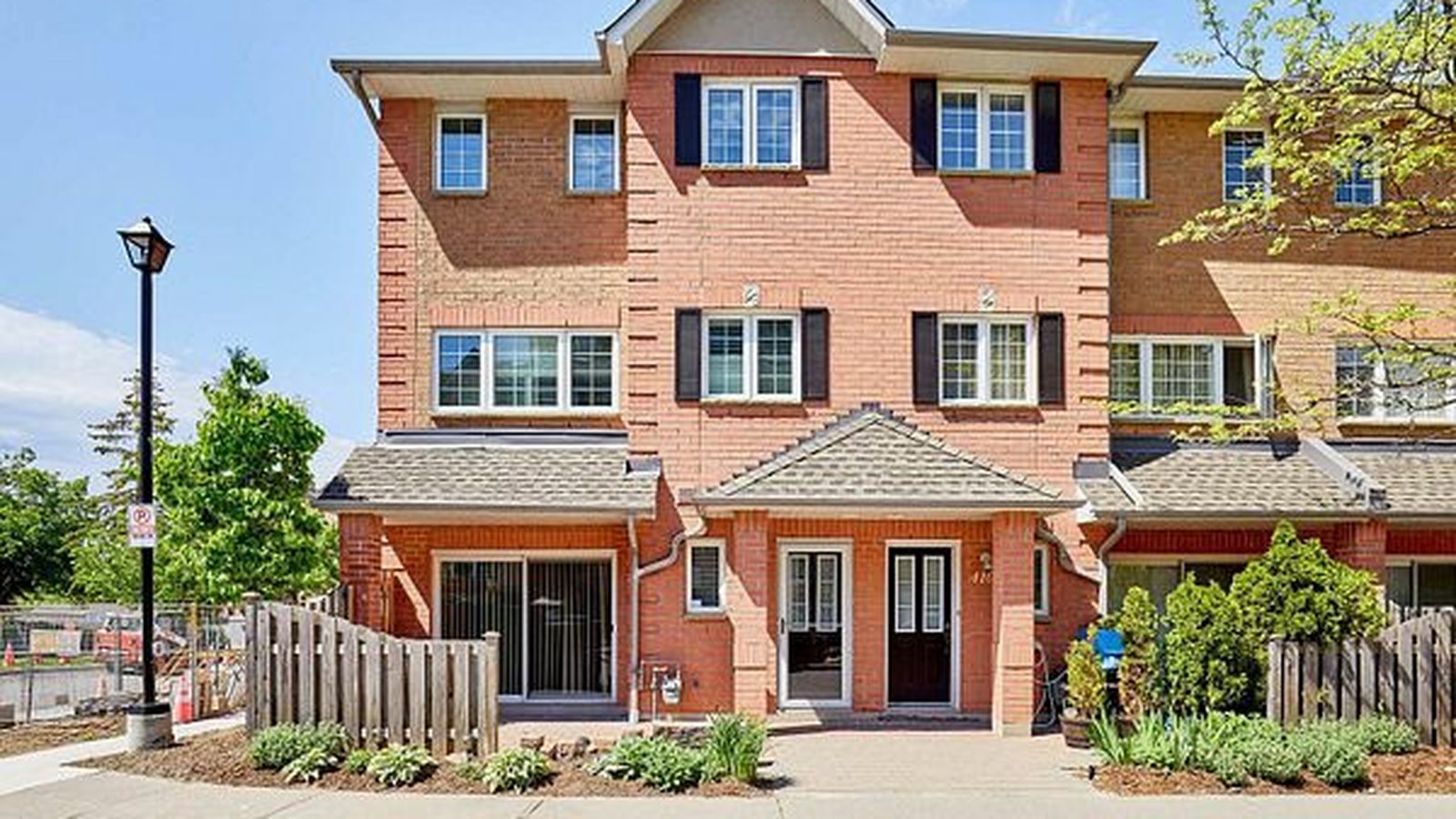 1400 The Esplanade N #411, Pickering: a three-storey red brick corner townhome in a gated Town Centre community, listed by The Gordon Brothers Team, Revel Realty Inc., Brokerage