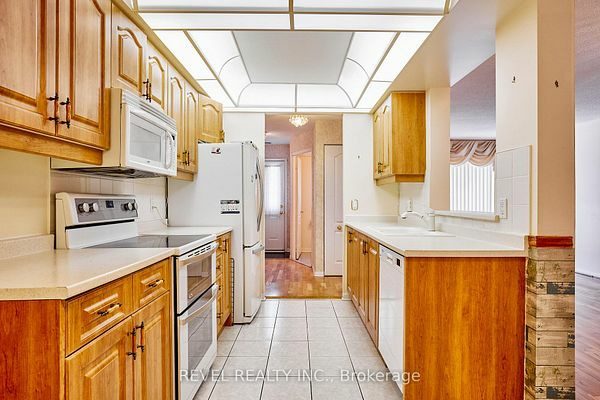 Kitchen looking toward the stairs at 1400 The Esplanade N #411, Pickering, listed by The Gordon Brothers Team, Revel Realty Inc., Brokerage