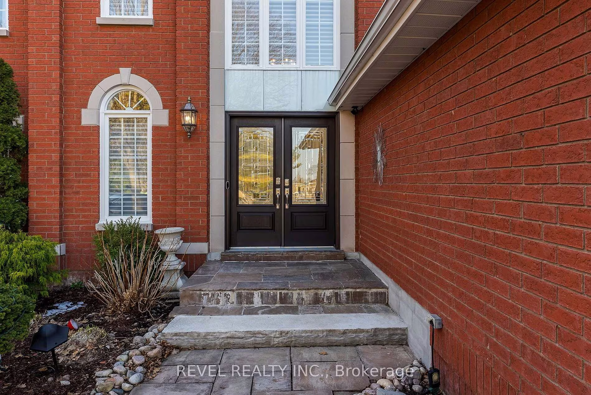 Front entrance of 1486 Ashwood Gate, Pickering, with double glass-panel doors and a brick exterior, listed by The Gordon Brothers Team, Revel Realty Inc., Brokerage