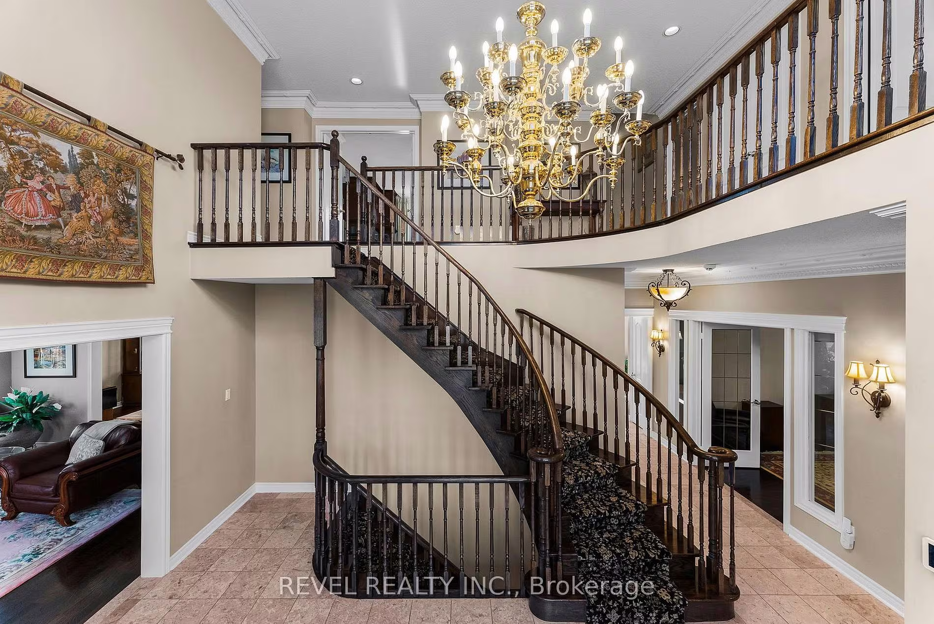 Curved staircase with a wraparound upper landing and tapestry at 1486 Ashwood Gate, Pickering, listed by The Gordon Brothers Team, Revel Realty Inc., Brokerage